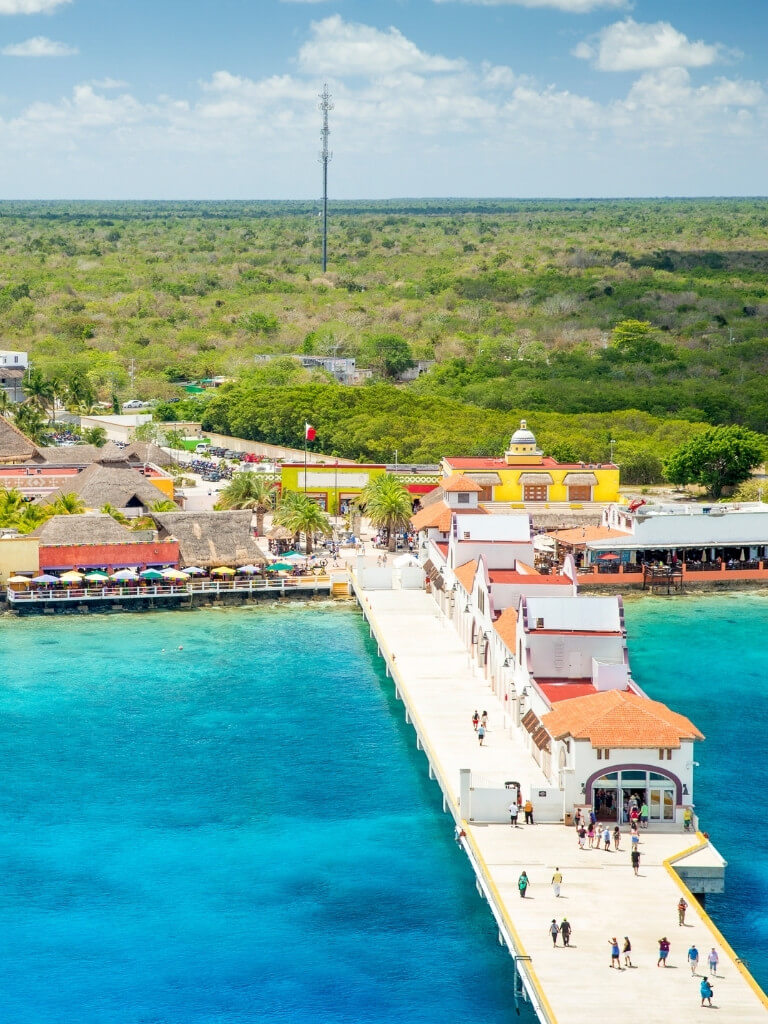 Cozumel's passenger ferry terminal with the ocean in the foreground and jungle in the background