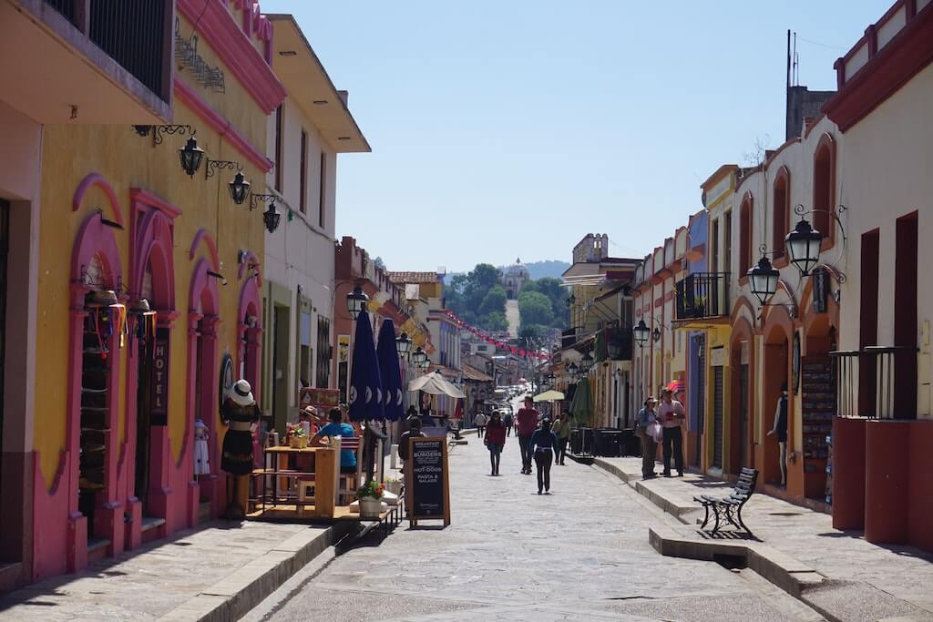 People wander along the pedestrian street in San Cristobal de Las Casas in Chiapas. The street is lined with brightly painted colonial buidlings