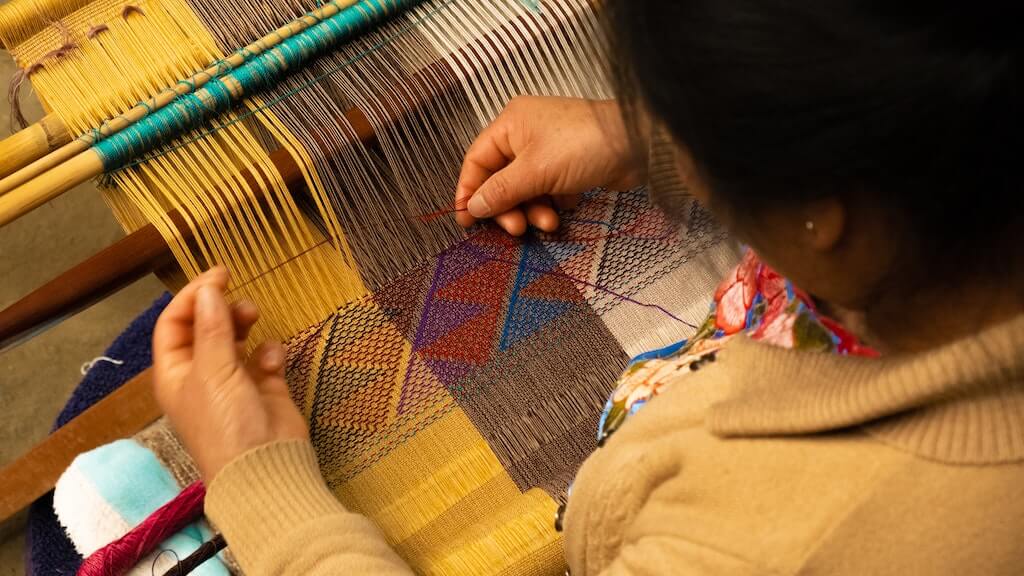 A woman hand-weaves a blanket in Zinacantán, Chiapas