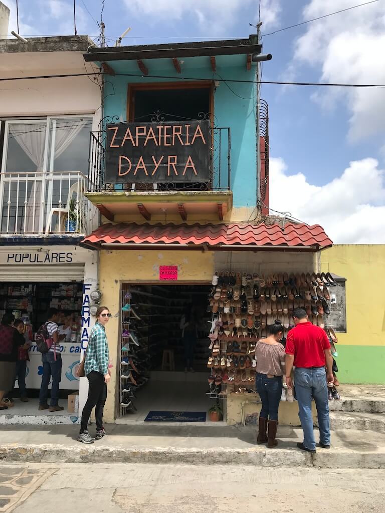 shoppers admire a display of leather shoes outside a simple in Naolinco, Veracruz