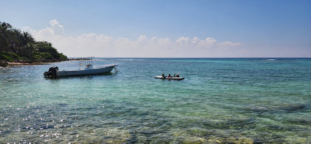 Visitors floating in the clear ocean waters at Paamul Beach in Playa del Carmen, MX.