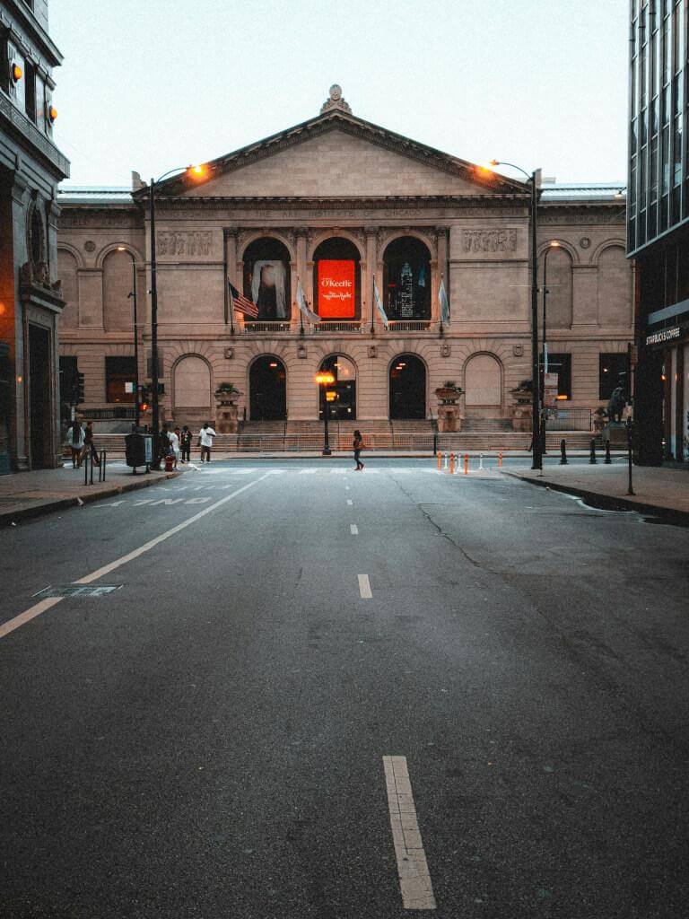 Must-Know Safety Tips When Traveling To Chicago During Winter Dramatic view of the art institute of chicago at dusk, featuring an empty street. Travleing to chicago during winter still takes diligence as a driver on the urban roads