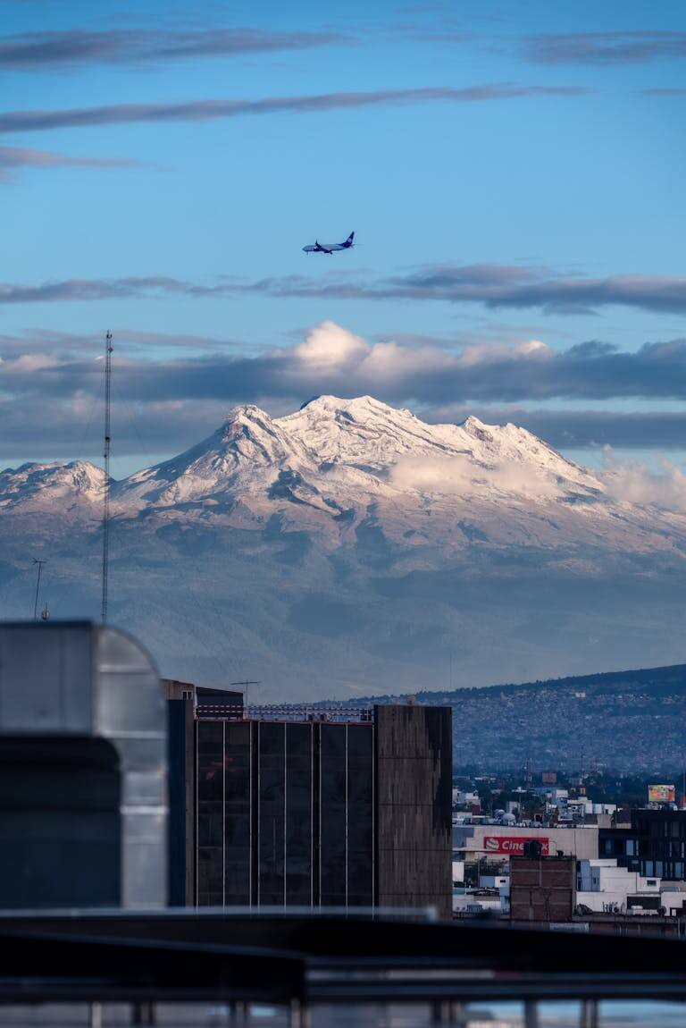 Aerial shot of mexico city skyline with a snow-capped mountain in the background during winter