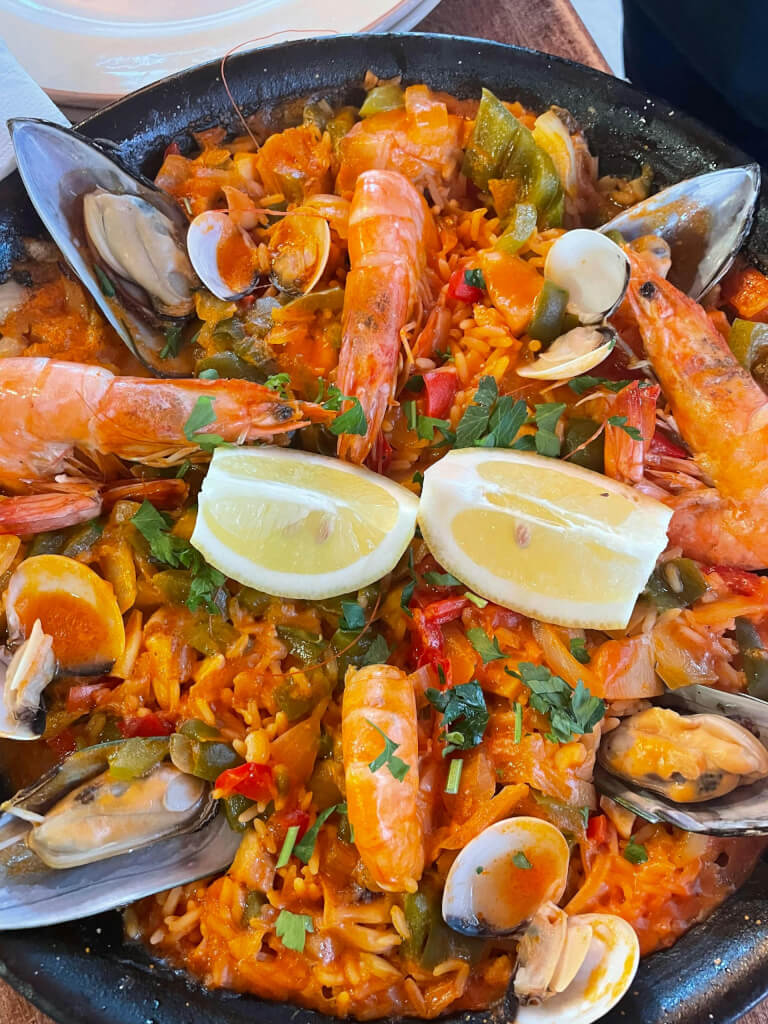 7 Global Food Festivals Deserving Of Your Next Trip? Close-up of traditional spanish seafood paella with shrimp, mussels, and lemon slices, just absolutely perfect for global food festivals