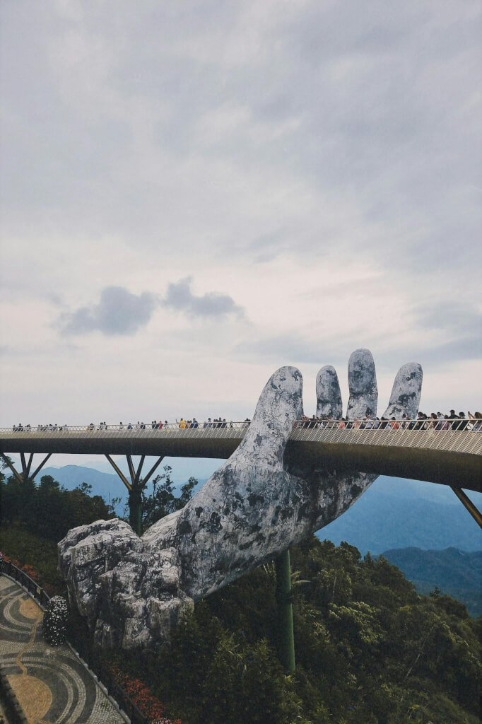 Giant hands supporting a scenic ferry in southeast asia.